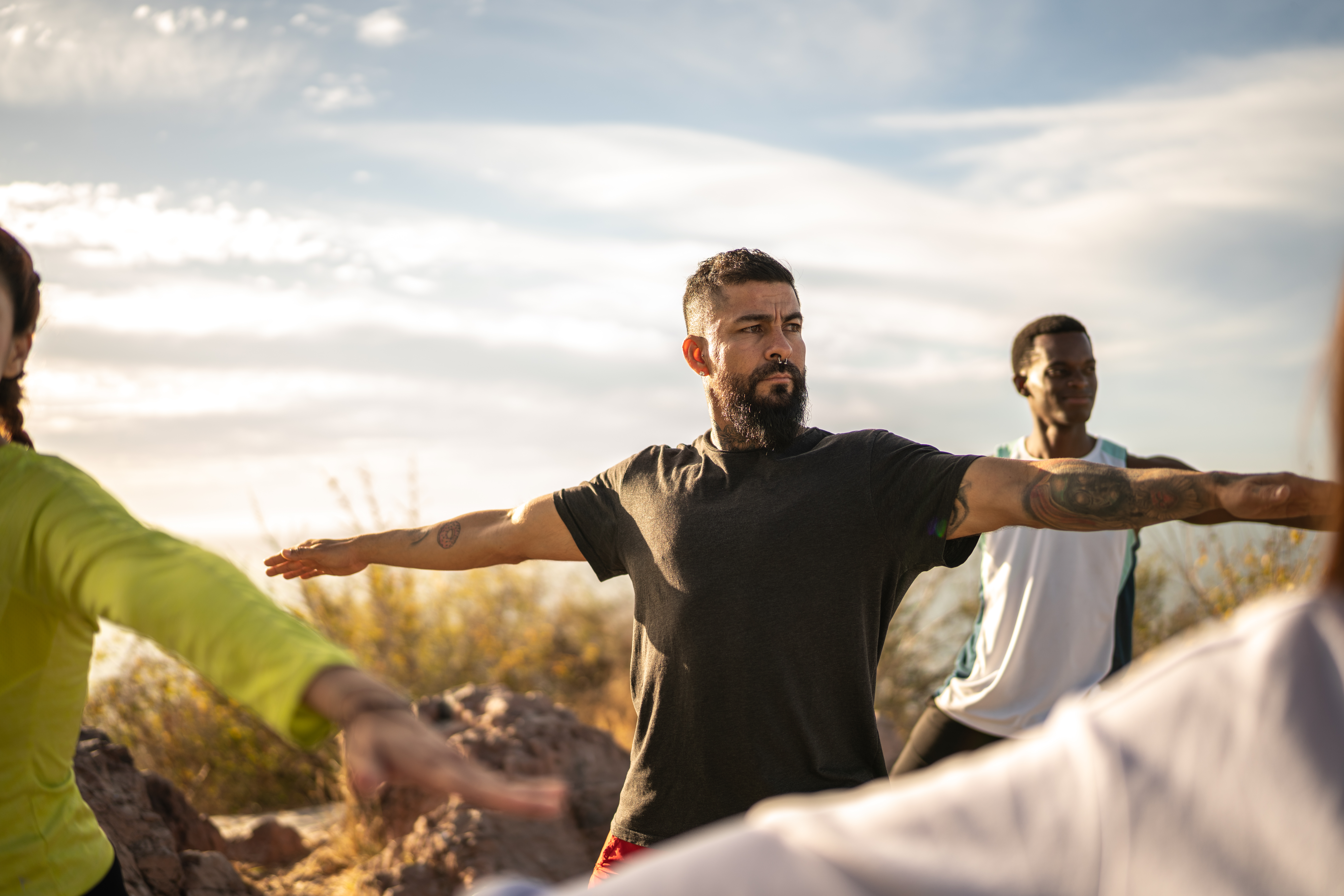 Mature man during an yoga class outdoors